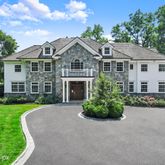 a front view of a house with a garden and porch