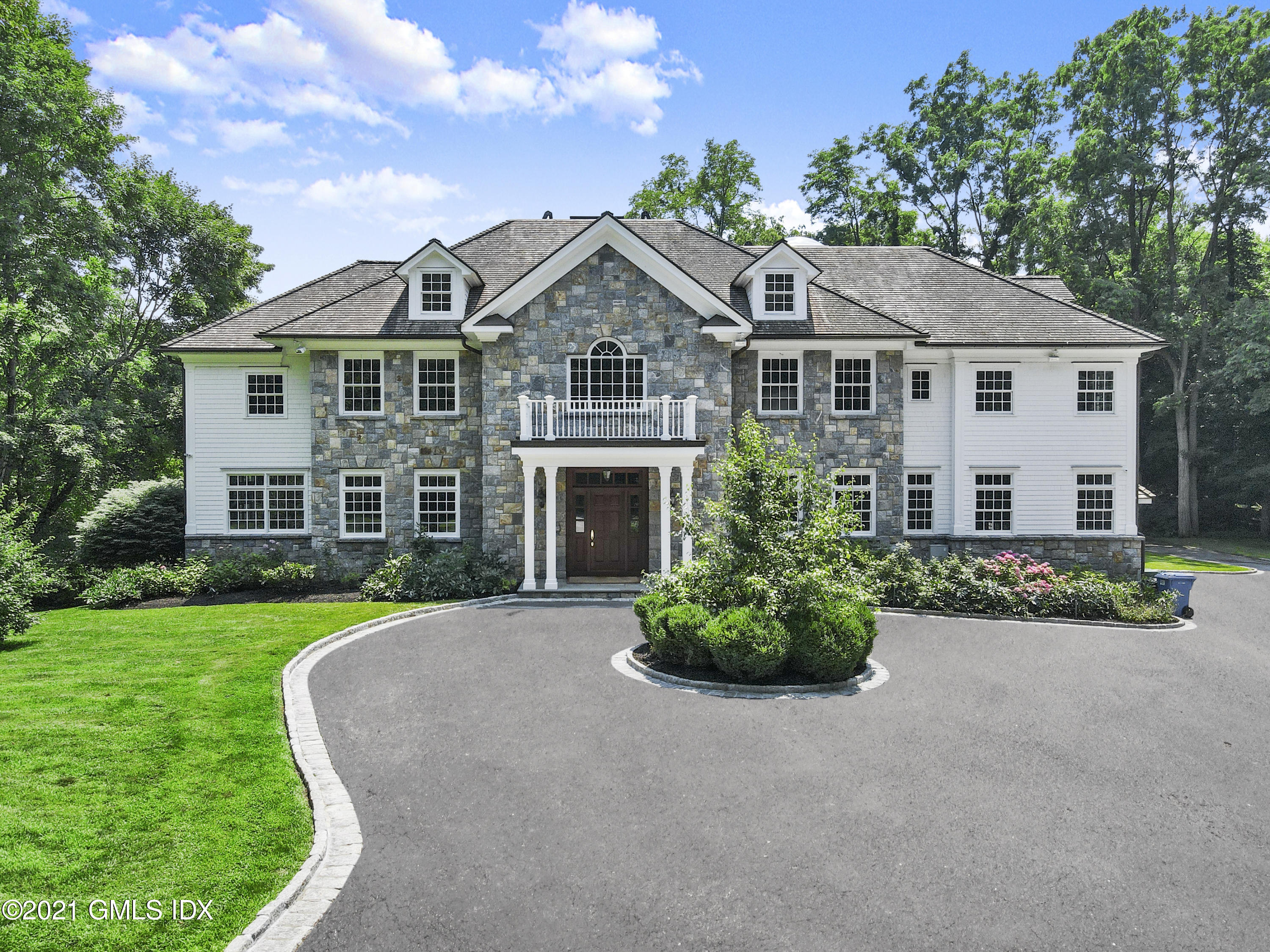 245 Bedford Road Greenwich, CT 06831 - Photo 1 of 27 a front view of a house with a garden and porch