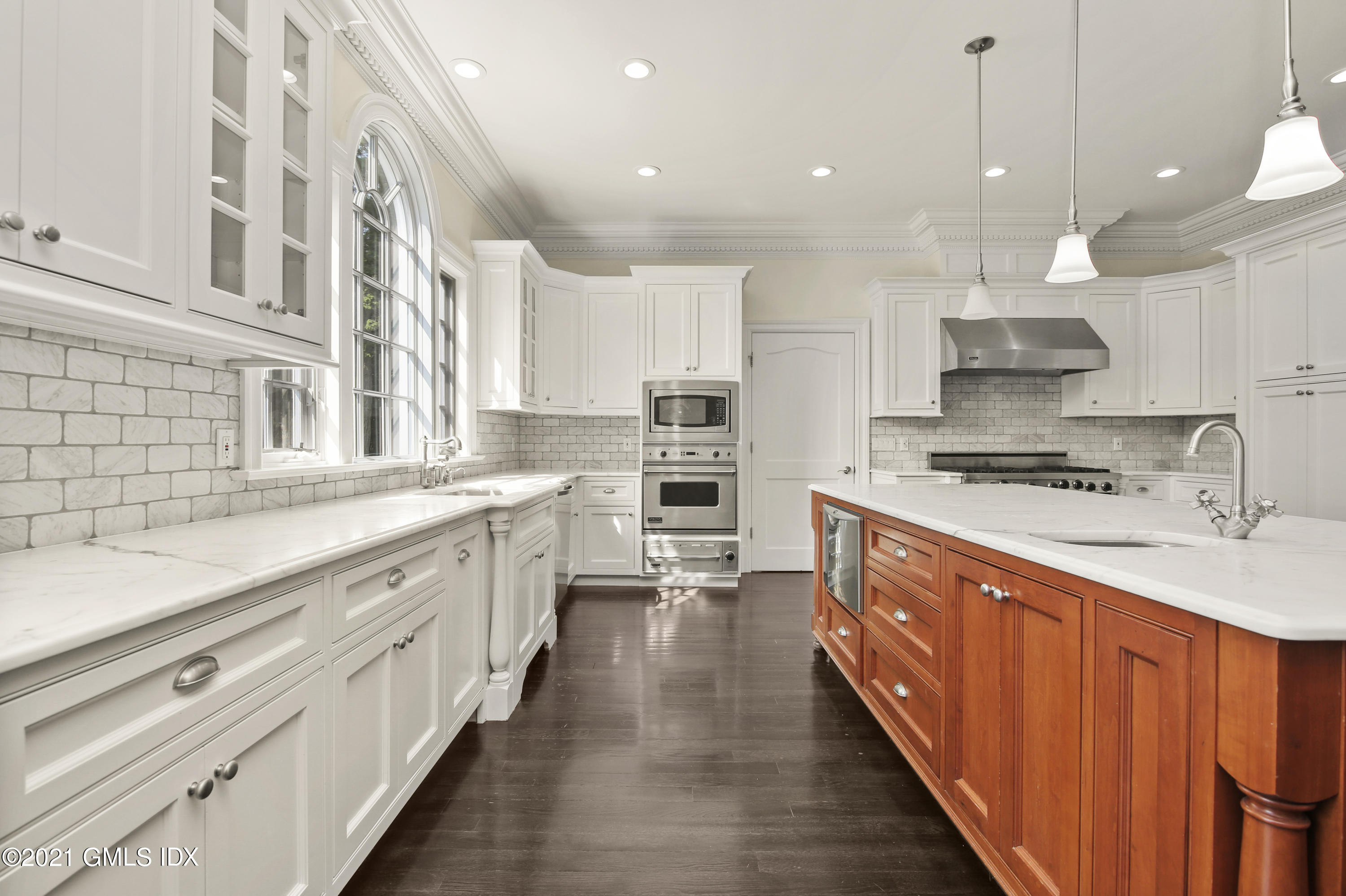 245 Bedford Road Greenwich, CT 06831 - Photo 11 of 27 a kitchen with stainless steel appliances a sink stove and cabinets