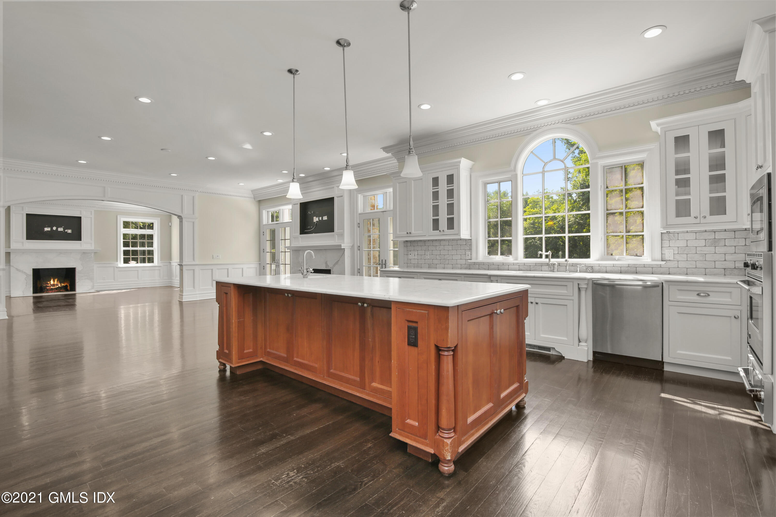 245 Bedford Road Greenwich, CT 06831 - Photo 12 of 27 a kitchen with stainless steel appliances granite countertop a stove a sink dishwasher a refrigerator and white cabinets with wooden floor
