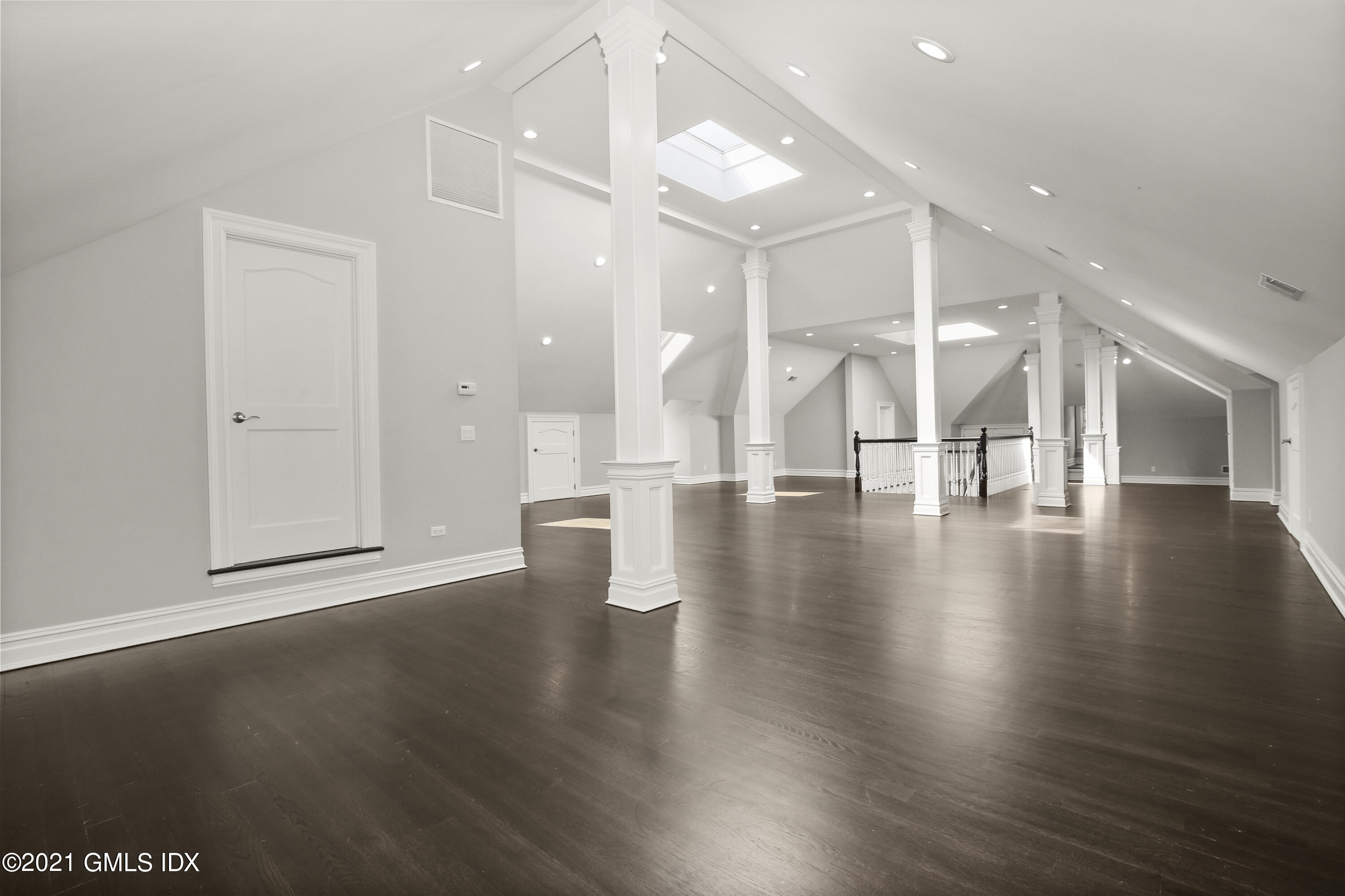 245 Bedford Road Greenwich, CT 06831 - Photo 19 of 27 a view of an empty room with wooden floor and a large window