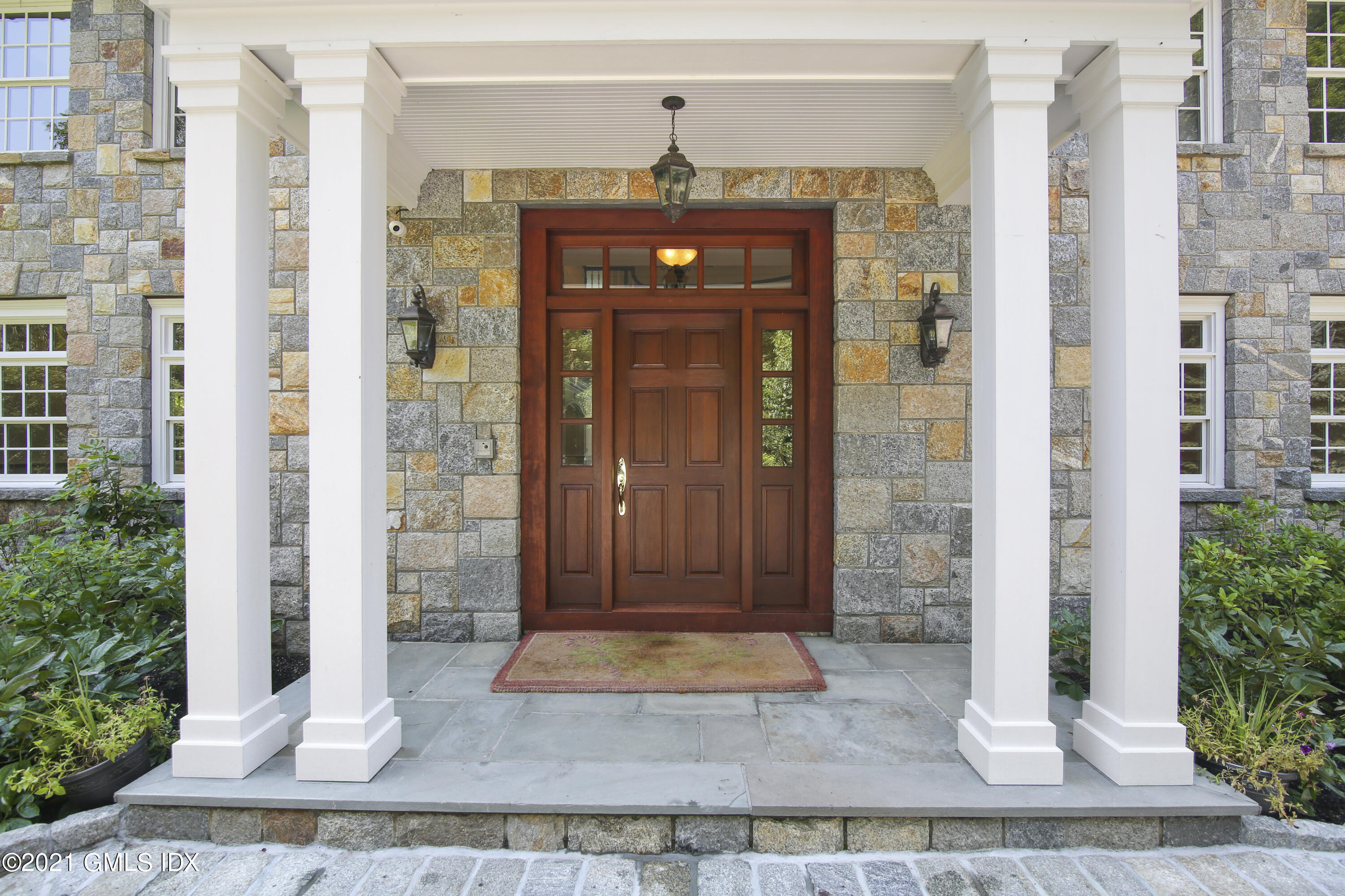 245 Bedford Road Greenwich, CT 06831 - Photo 2 of 27 a front view of a house with a porch