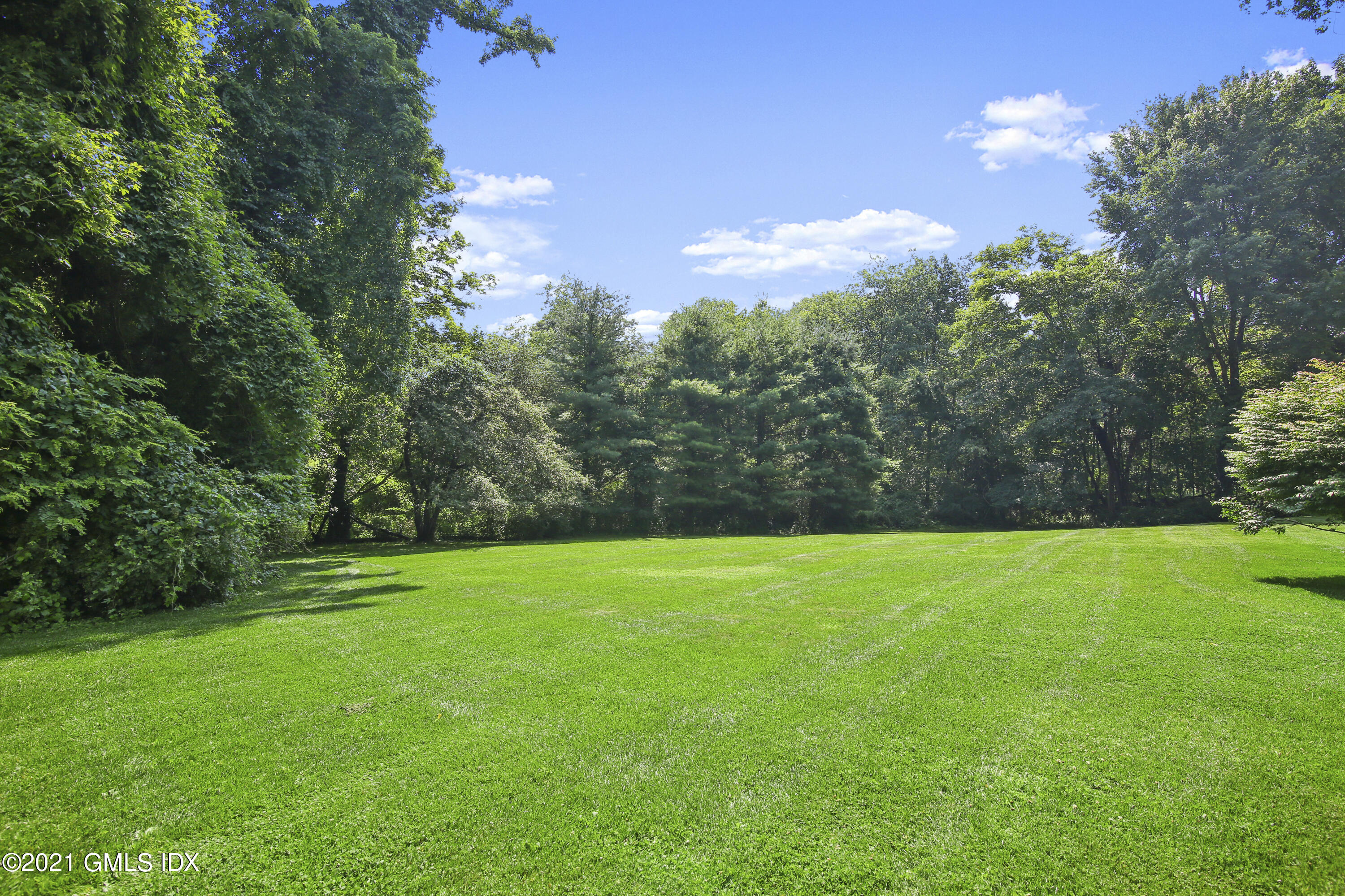 245 Bedford Road Greenwich, CT 06831 - Photo 24 of 27 a view of a grassy field with trees