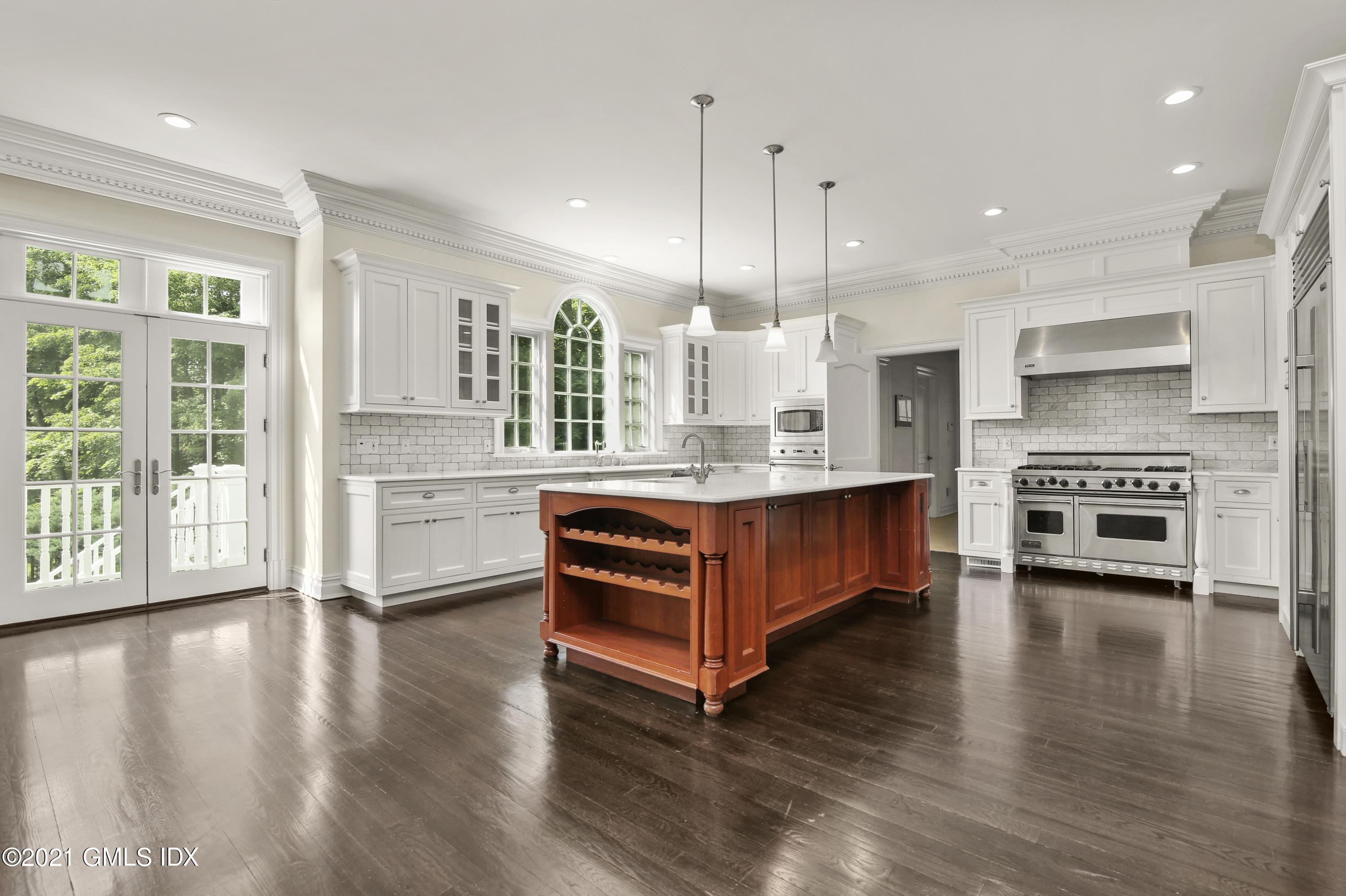 245 Bedford Road Greenwich, CT 06831 - Photo 10 of 27 a large kitchen with stainless steel appliances granite countertop a stove a refrigerator a kitchen island a stove and a wooden floors