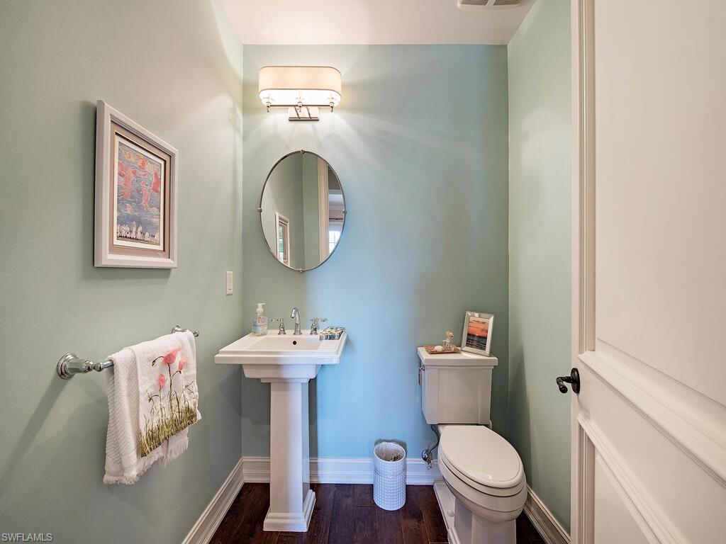 613 14th Avenue South Naples, FL 34102 - Photo 17 of 28 a bathroom with a sink mirror toilet and vanity