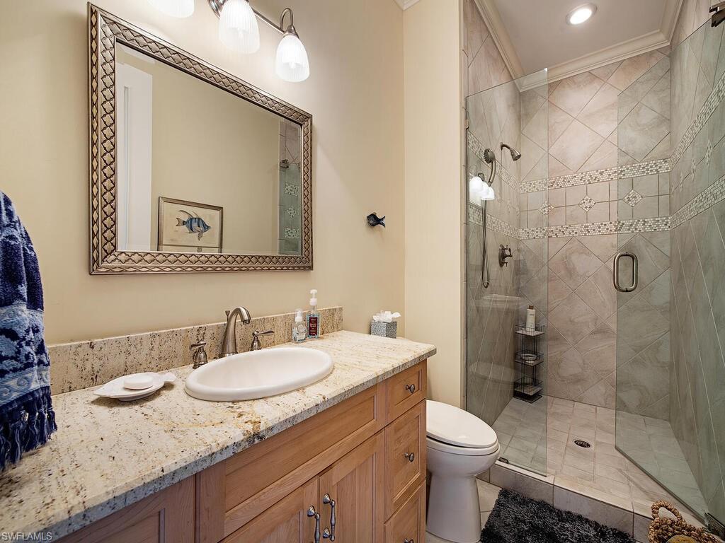 613 14th Avenue South Naples, FL 34102 - Photo 22 of 28 a bathroom with a sink a toilet and shower