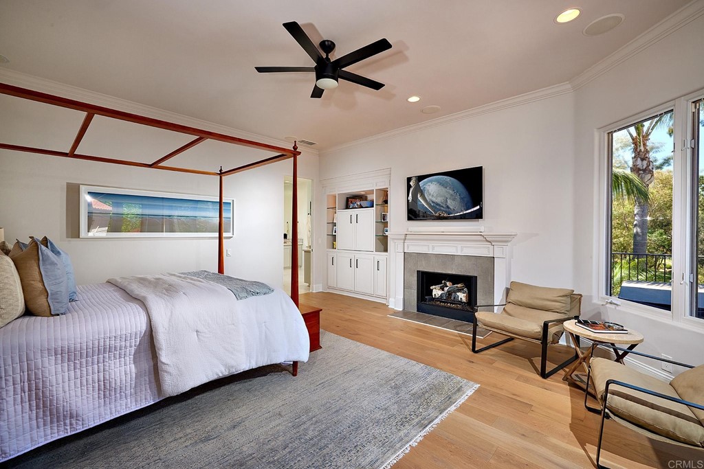 17356 Circa Oriente Rancho Santa Fe, CA 92067 - Photo 16 of 29 a bedroom with a bed a fireplace and a large window
