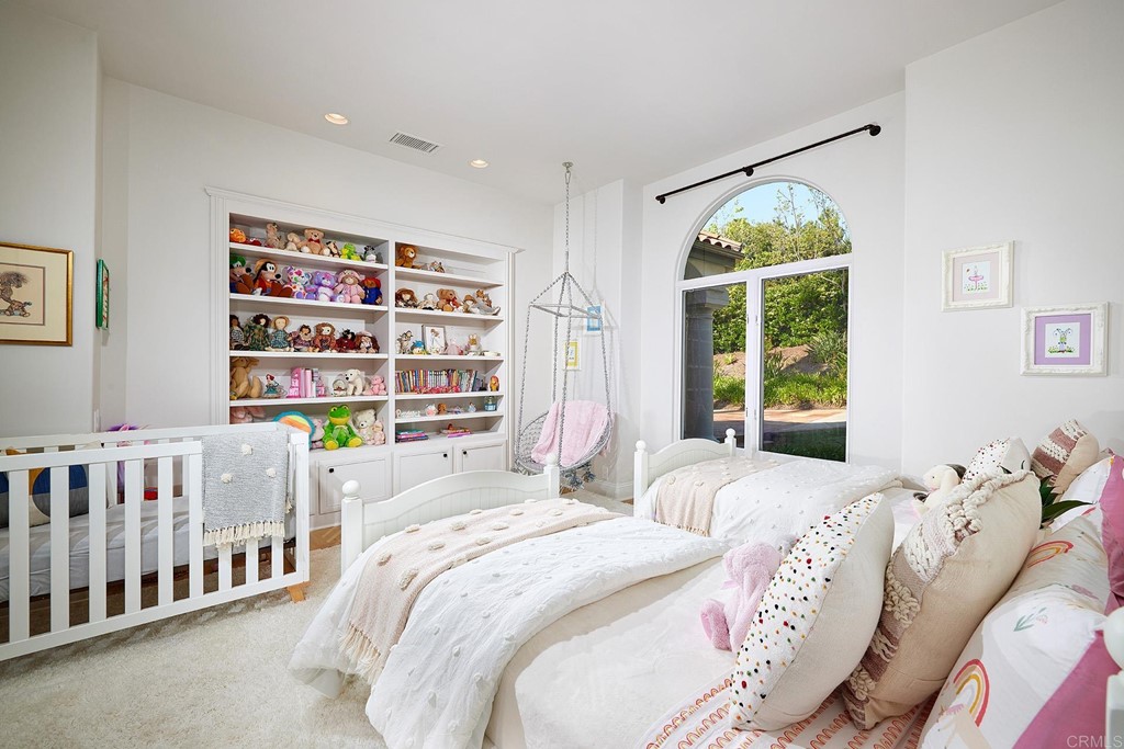 17356 Circa Oriente Rancho Santa Fe, CA 92067 - Photo 18 of 29 a bedroom with a bed and a book shelf