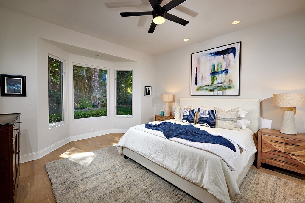 17356 Circa Oriente Rancho Santa Fe, CA 92067 - Photo 19 of 29 a spacious bedroom with a bed and glass window