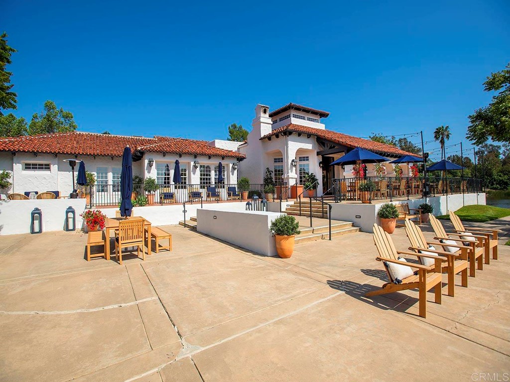 17356 Circa Oriente Rancho Santa Fe, CA 92067 - Photo 23 of 29 a view of a patio with dining table and chairs with wooden fence