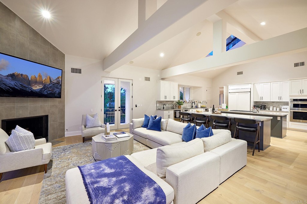 17356 Circa Oriente Rancho Santa Fe, CA 92067 - Photo 3 of 29 a living room with furniture kitchen view and a fireplace