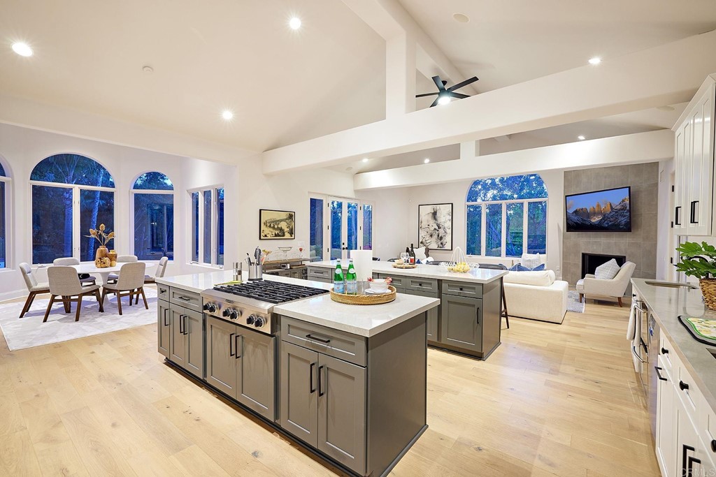 17356 Circa Oriente Rancho Santa Fe, CA 92067 - Photo 5 of 29 a kitchen with a stove a sink a dining table and chairs