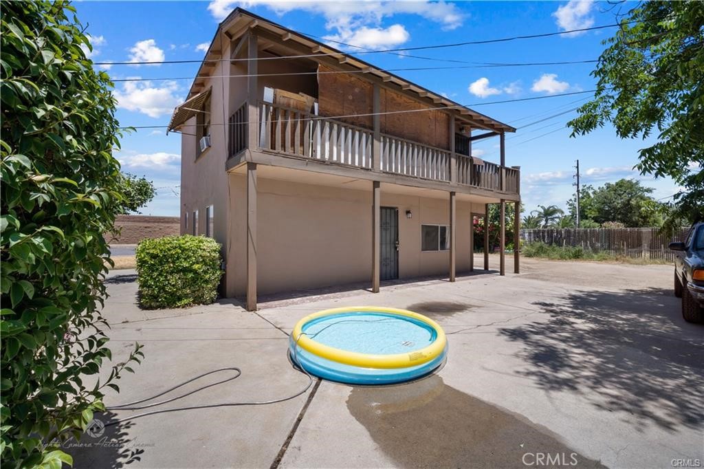 208 Brink Drive Bakersfield, CA 93304 - Photo 4 of 10 a view of a white house with a swimming pool