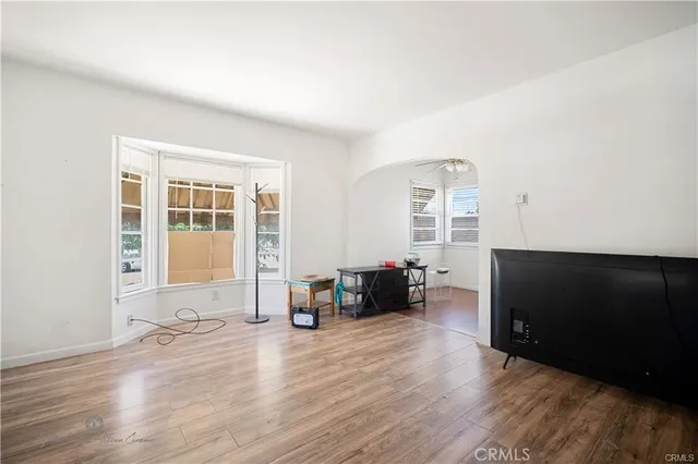 an empty room with furniture and a window