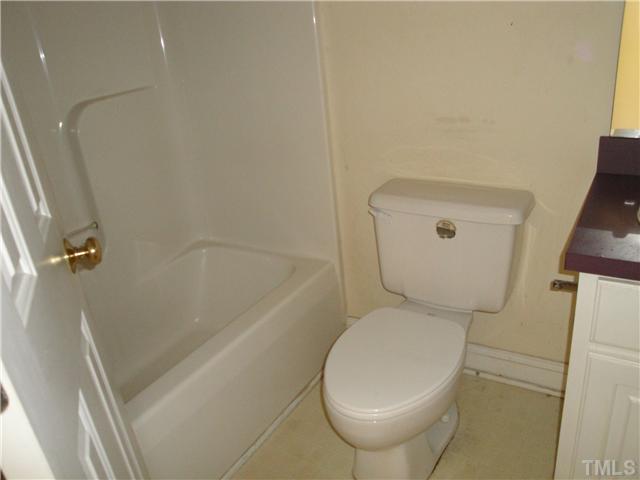 9921 Old Middlesex Road Middlesex, NC 27557 - Photo 9 of 11 a bathroom with a toilet and a bathtub