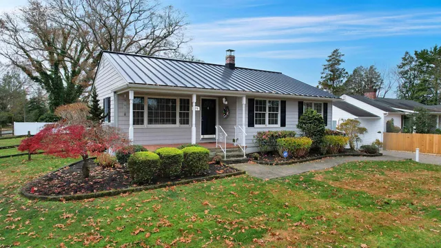 a view of a house with backyard sitting area and garden