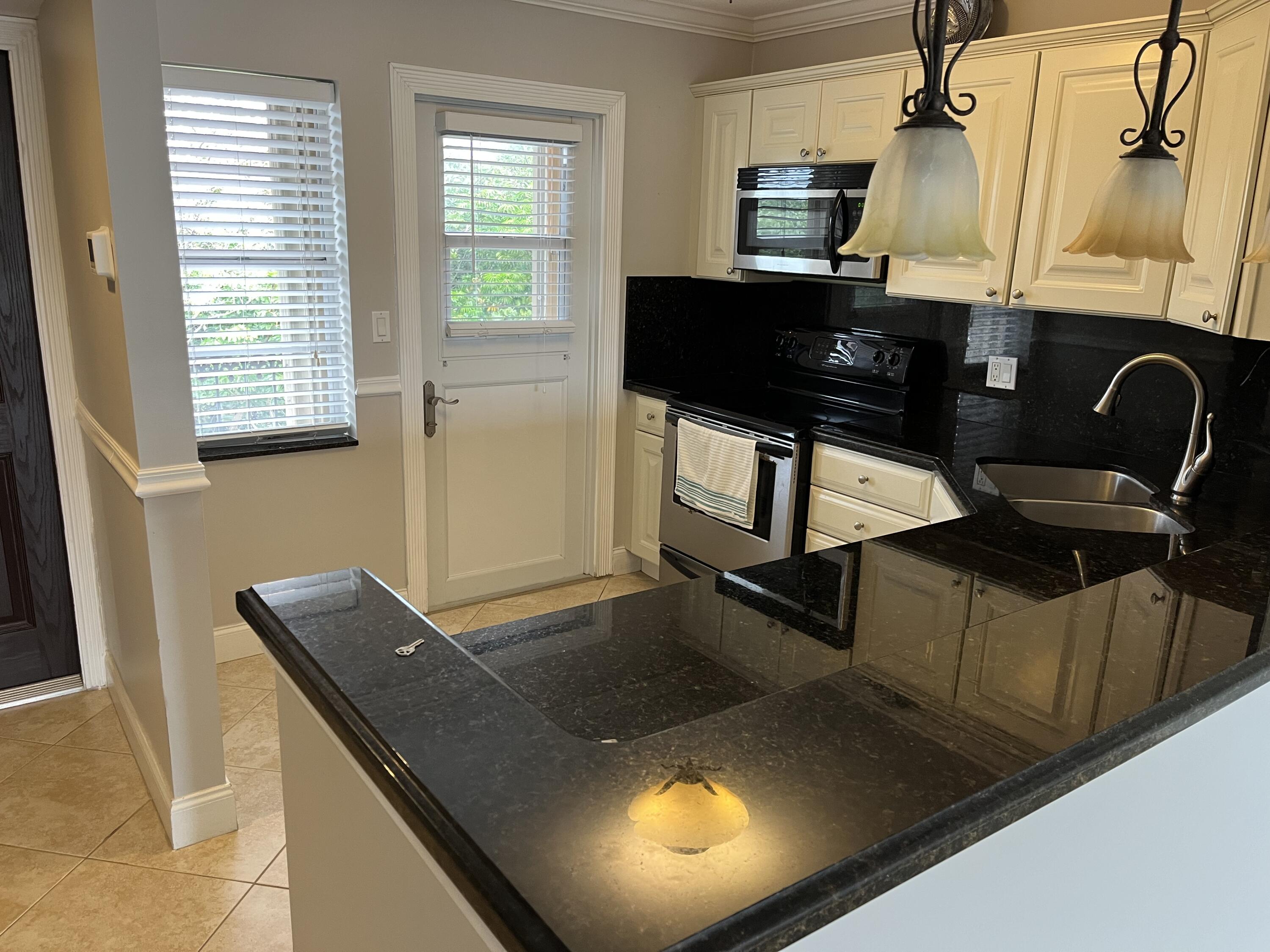 2871 North Ocean Boulevard, Unit V345 Boca Raton, FL 33431 - Photo 7 of 13 a view of kitchen with a window