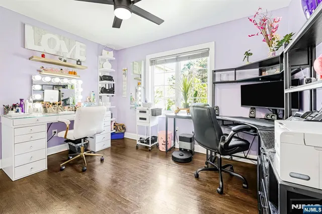 a view of a workspace with furniture and a window