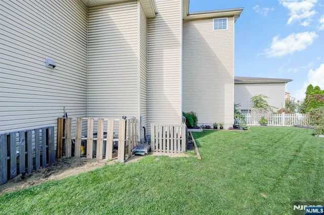 a backyard of a house with table and chairs
