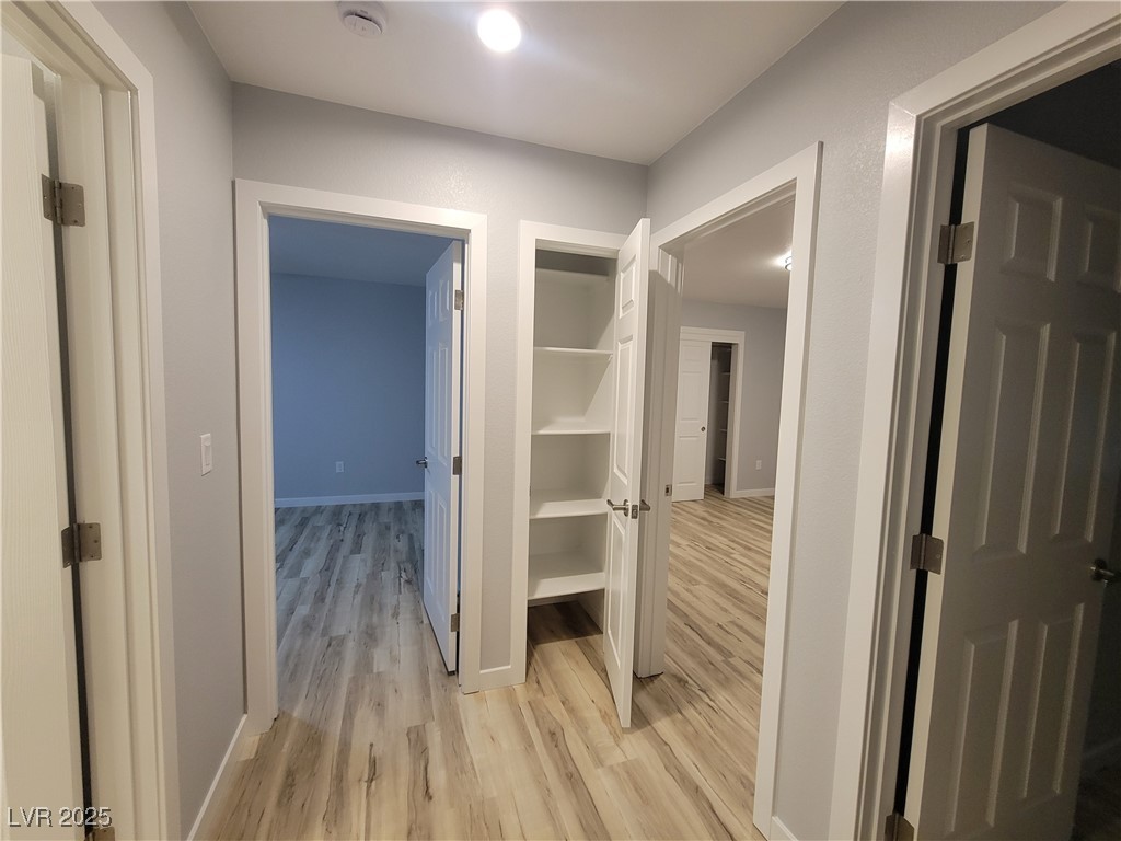 1021 East Manse Road Pahrump, NV 89048 - Photo 16 of 25 Hallway with light wood-type flooring and baseboards