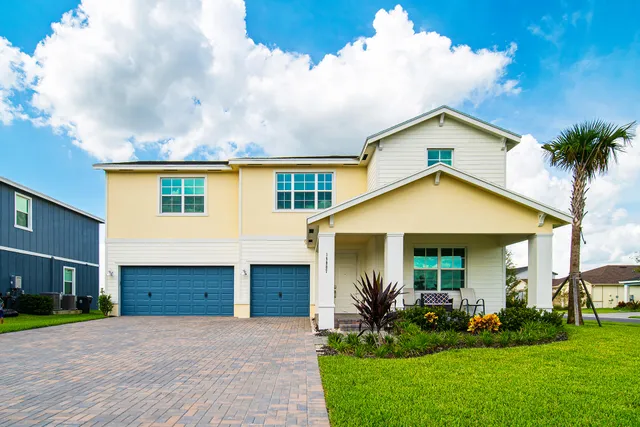 a front view of a house with a yard and garage