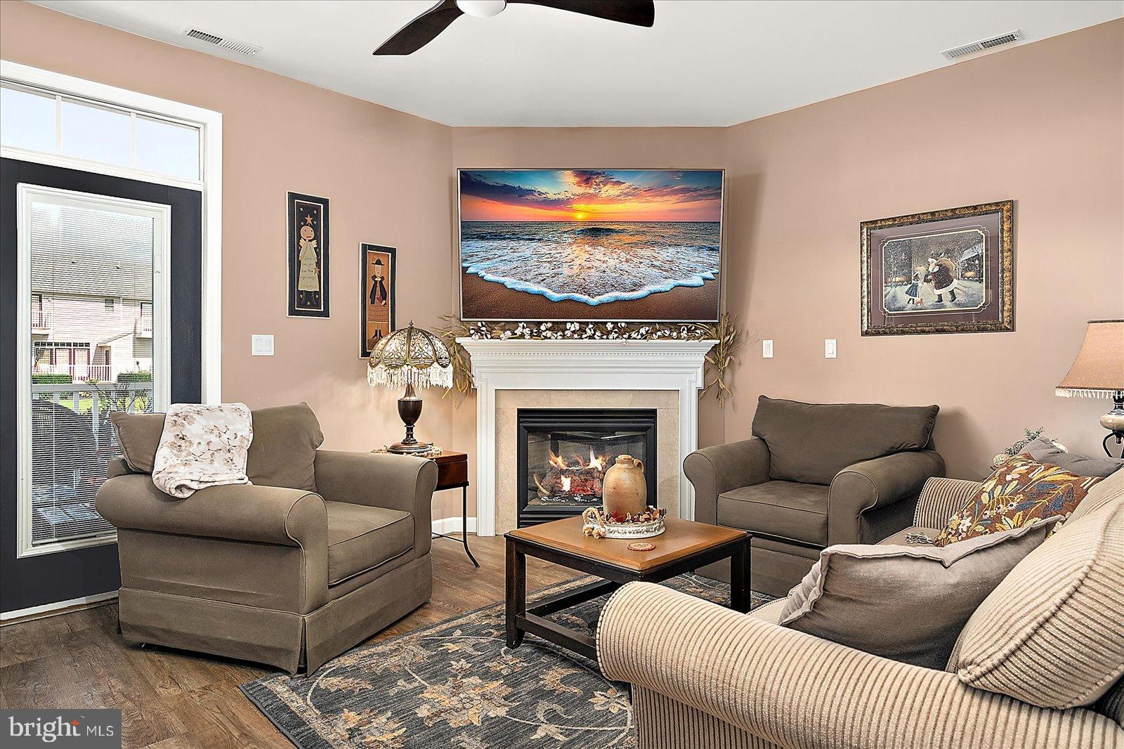 10050 Golf Course Road, Unit 6 Ocean City, MD 21842 - Photo 21 of 60 Cozy living space with serene coastal art.