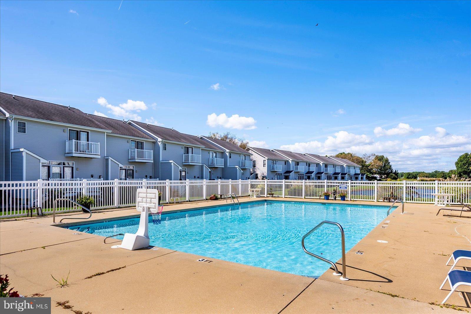 10050 Golf Course Road, Unit 6 Ocean City, MD 21842 - Photo 50 of 60 Sunny poolside retreat with serene views.