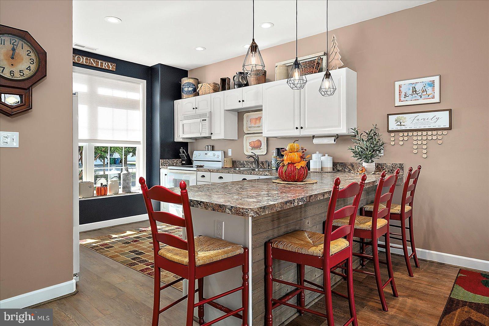 10050 Golf Course Road, Unit 6 Ocean City, MD 21842 - Photo 9 of 60 Charming kitchen with vibrant red accents.