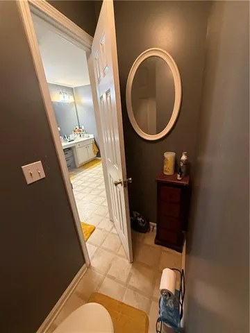 a bathroom with a sink mirror vanity and toilet