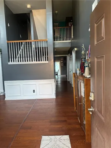 a view of entryway and hall with wooden floor