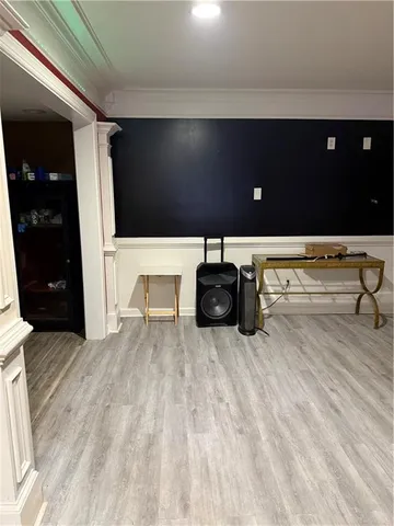 a bedroom with a bed and a refrigerator