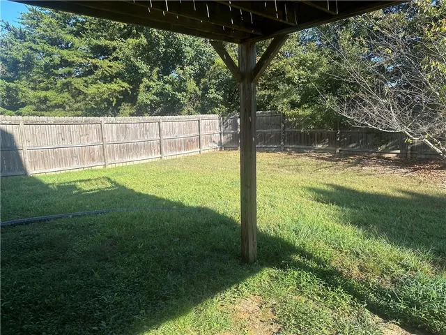a view of a wooden house with large windows