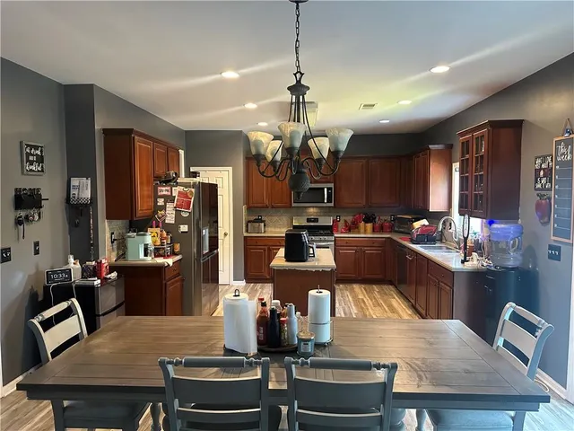 a kitchen with a dining table and chairs