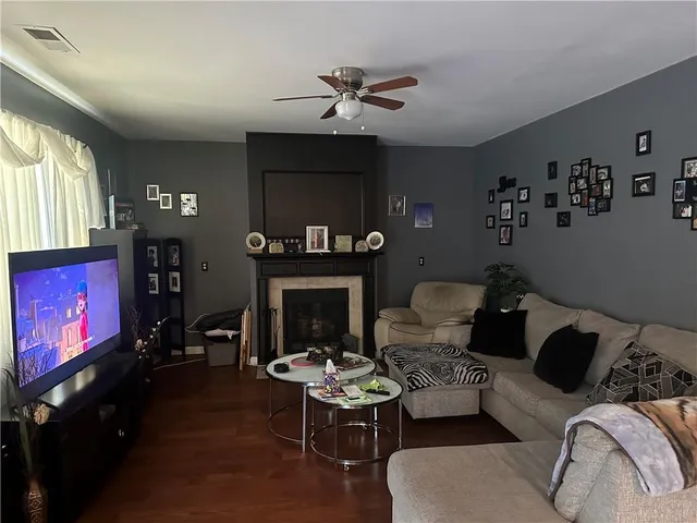 a living room with furniture and a fireplace