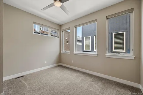 a bathroom with a granite countertop bathtub shower sink vanity mirror and toilet