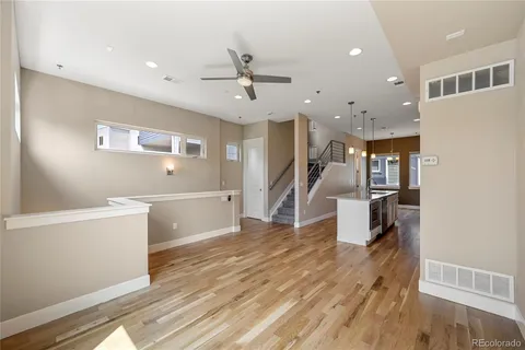 a large white kitchen with a sink stainless steel appliances and cabinets