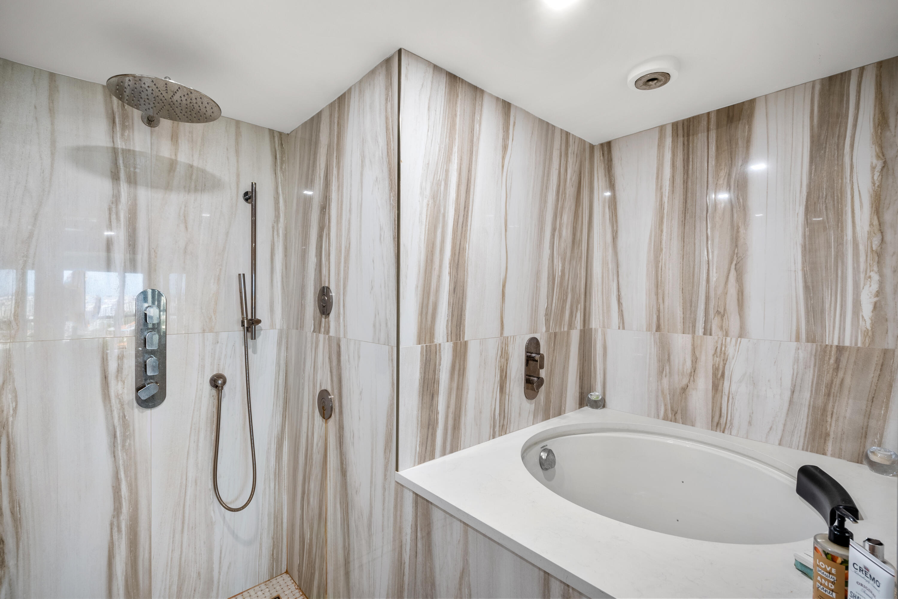 250 South Ocean Boulevard, Unit PH F Boca Raton, FL 33432 - Photo 18 of 30 a bathroom with a tub and shower