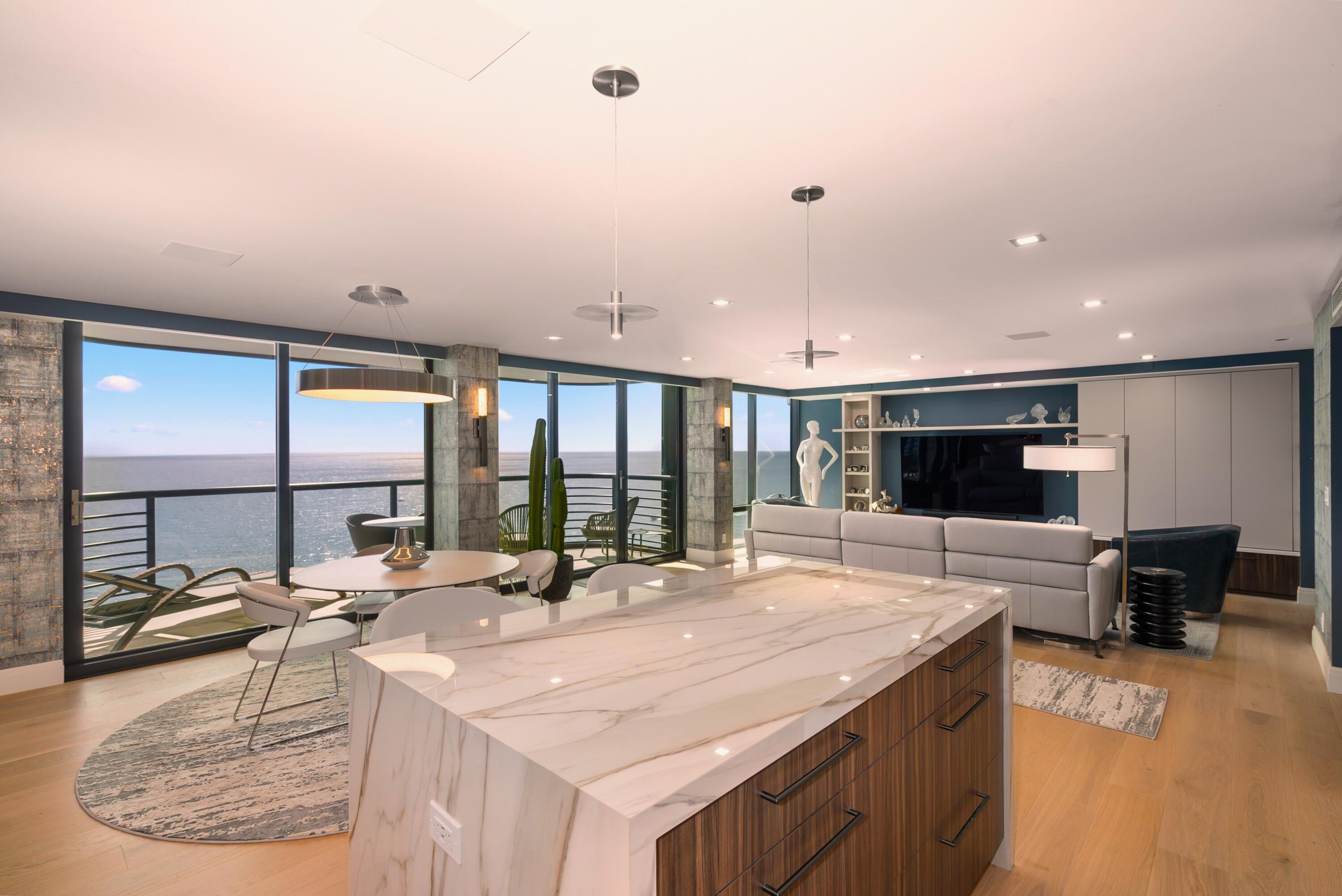250 South Ocean Boulevard, Unit PH F Boca Raton, FL 33432 - Photo 2 of 30 a kitchen with stainless steel appliances kitchen island granite countertop a sink and cabinets