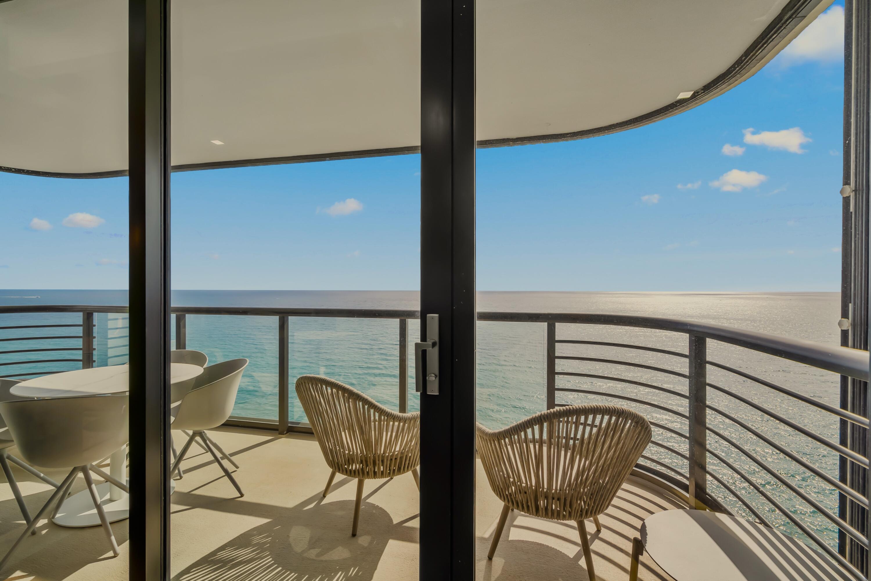 250 South Ocean Boulevard, Unit PH F Boca Raton, FL 33432 - Photo 10 of 30 a balcony with couple of chairs and wooden floor