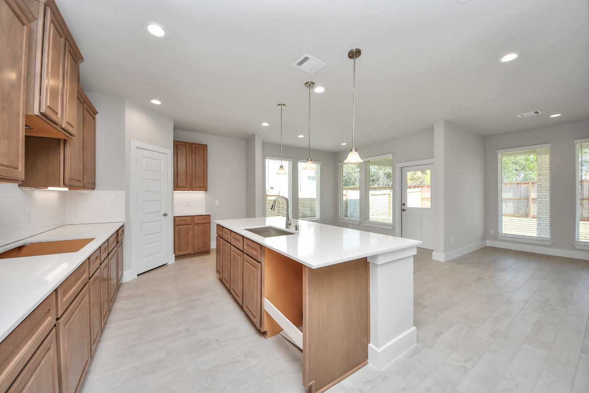 3114 North Spring Drive Spring, TX 77373 - Photo 12 of 45 a large kitchen with kitchen island a sink stainless steel appliances and cabinets