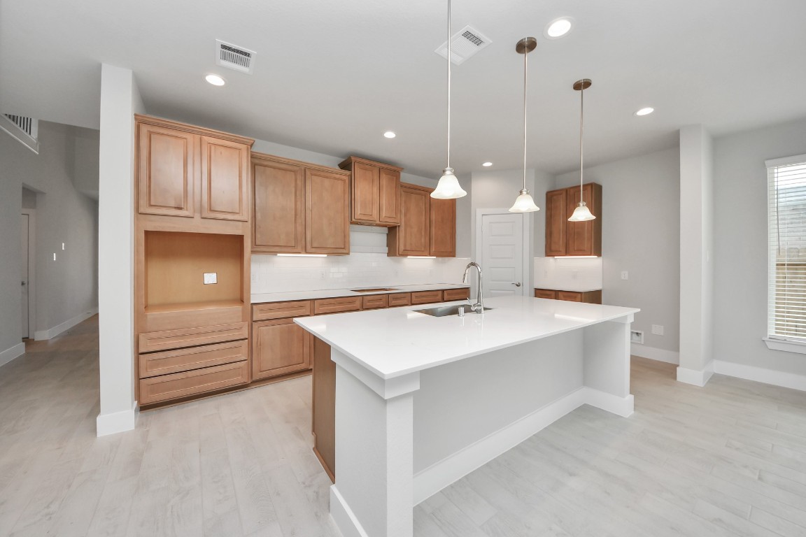 3114 North Spring Drive Spring, TX 77373 - Photo 13 of 45 a large kitchen with kitchen island a sink stainless steel appliances and cabinets