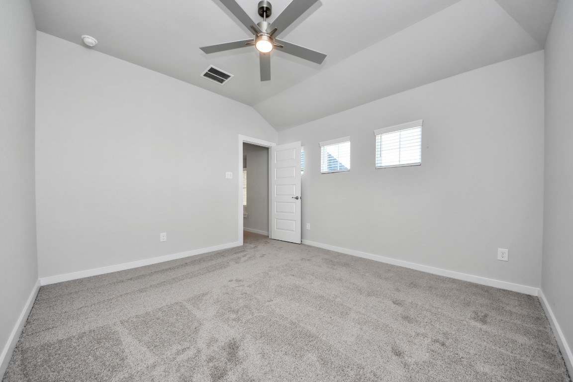 3114 North Spring Drive Spring, TX 77373 - Photo 37 of 45 an empty room with a ceiling fan and a window