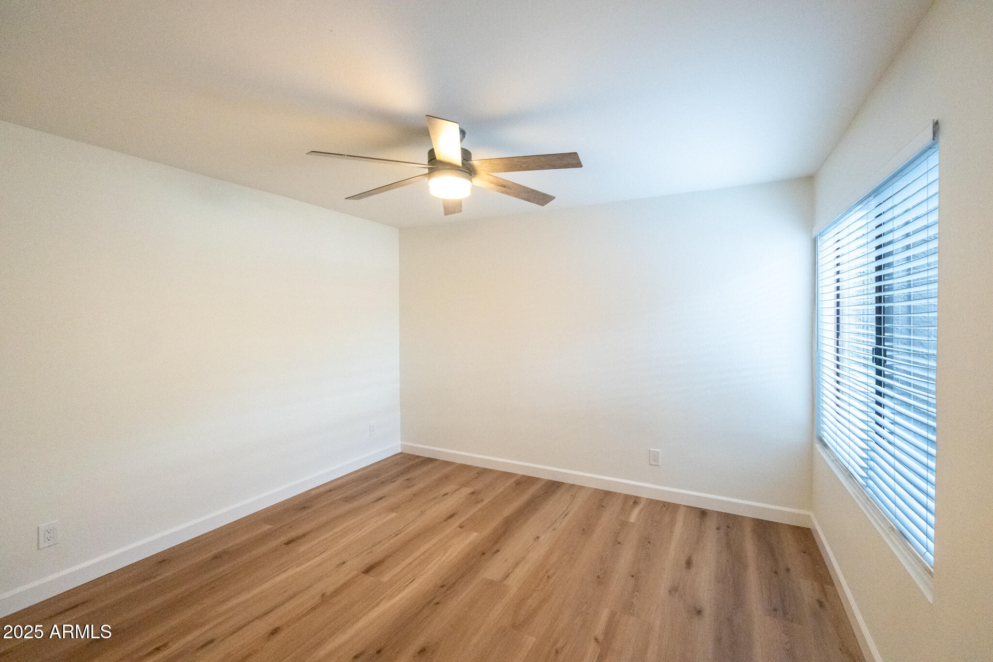 10115 East Mountain View Road, Unit 1089 Scottsdale, AZ 85258 - Photo 18 of 28 wooden floor in an empty room with a window