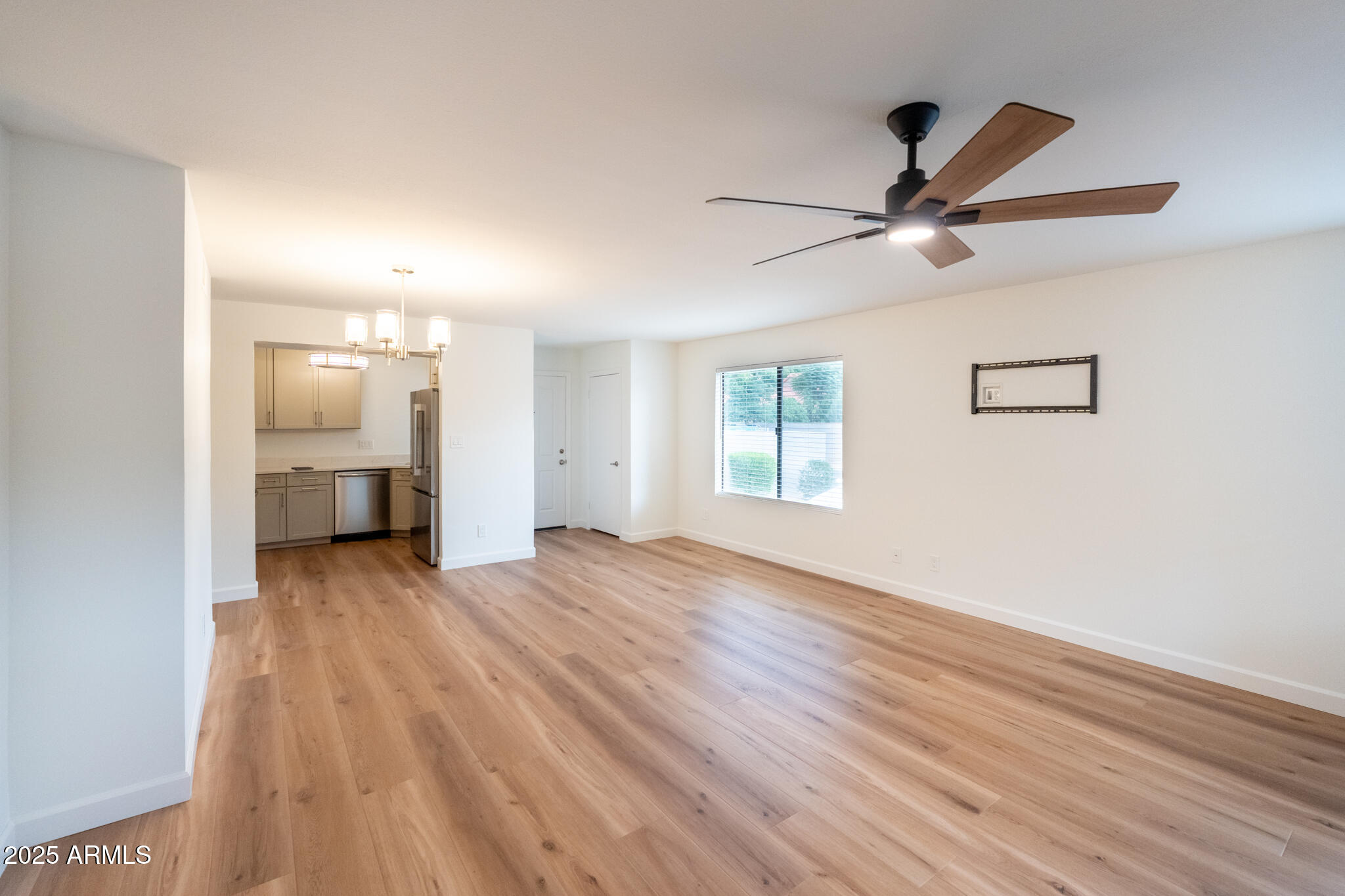 10115 East Mountain View Road, Unit 1089 Scottsdale, AZ 85258 - Photo 7 of 28 a view of empty room with wooden floor and fan