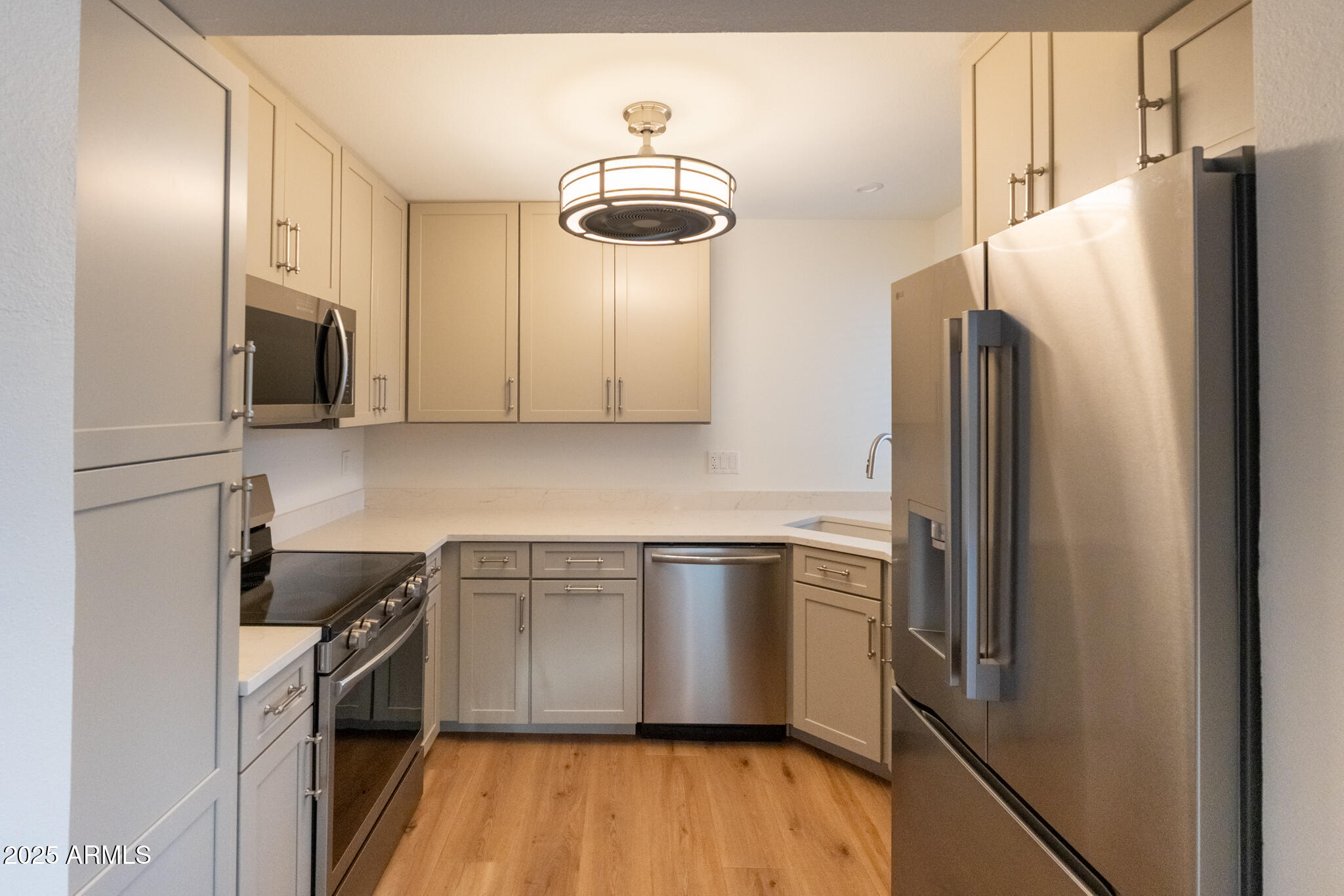 10115 East Mountain View Road, Unit 1089 Scottsdale, AZ 85258 - Photo 9 of 28 a kitchen with stainless steel appliances a refrigerator sink and microwave