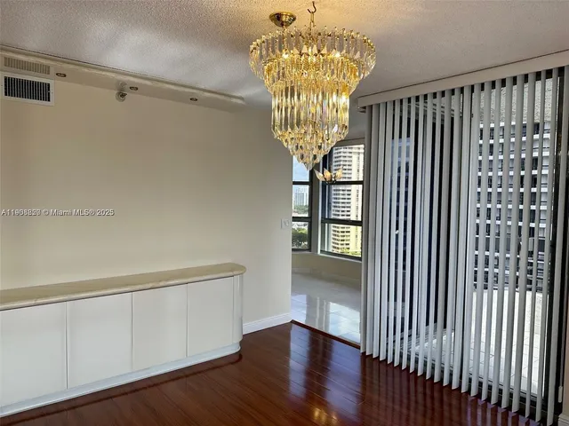 a view of a lobby area with furniture and chandelier