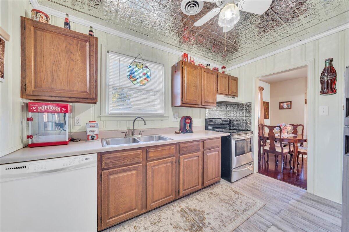 4820 Rutgers Street Northwest Roanoke, VA 24012 - Photo 13 of 41 a kitchen with stainless steel appliances granite countertop a sink cabinets and wooden floor