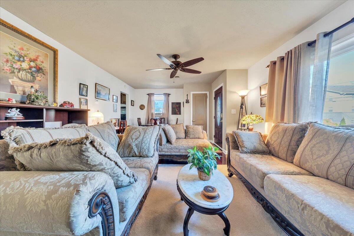 4820 Rutgers Street Northwest Roanoke, VA 24012 - Photo 8 of 41 a living room with furniture a chandelier and a dining table