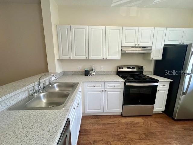 720 Celebration Avenue, Unit 235 Celebration, FL 34747 - Photo 4 of 16 a kitchen with a sink stove and cabinets