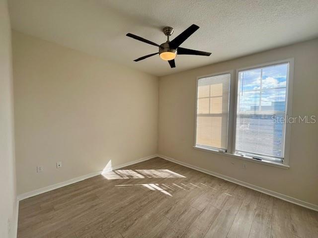 720 Celebration Avenue, Unit 235 Celebration, FL 34747 - Photo 7 of 16 an empty room with wooden floor and windows